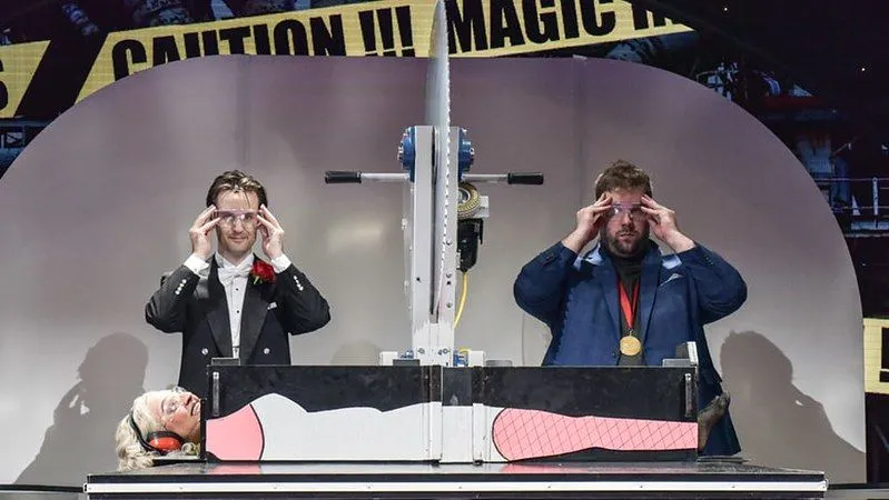 Actors performing a magic trick on stage at Magic Goes Wrong.