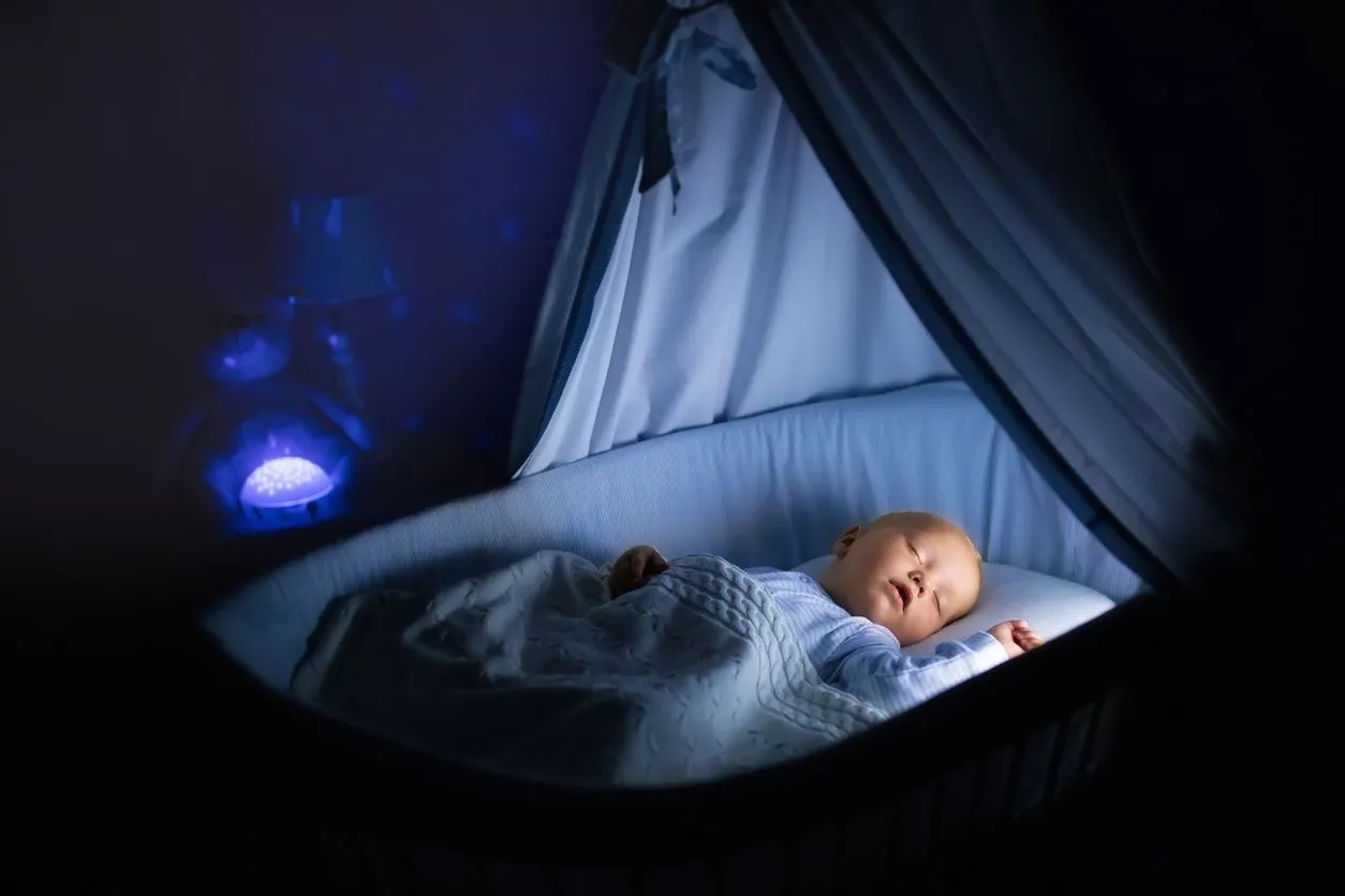Baby sleeping crib night light on