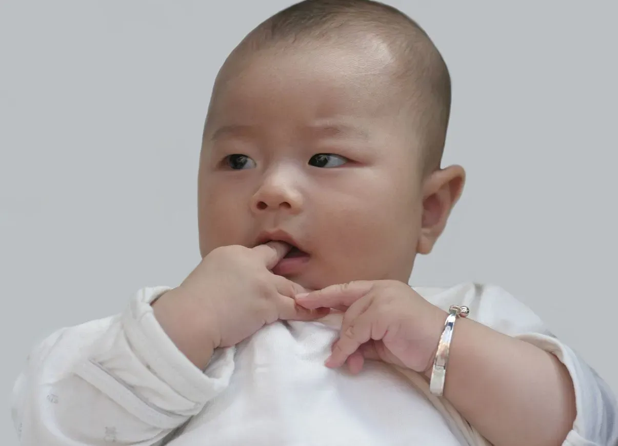 Baby wearing silver baby bracelet