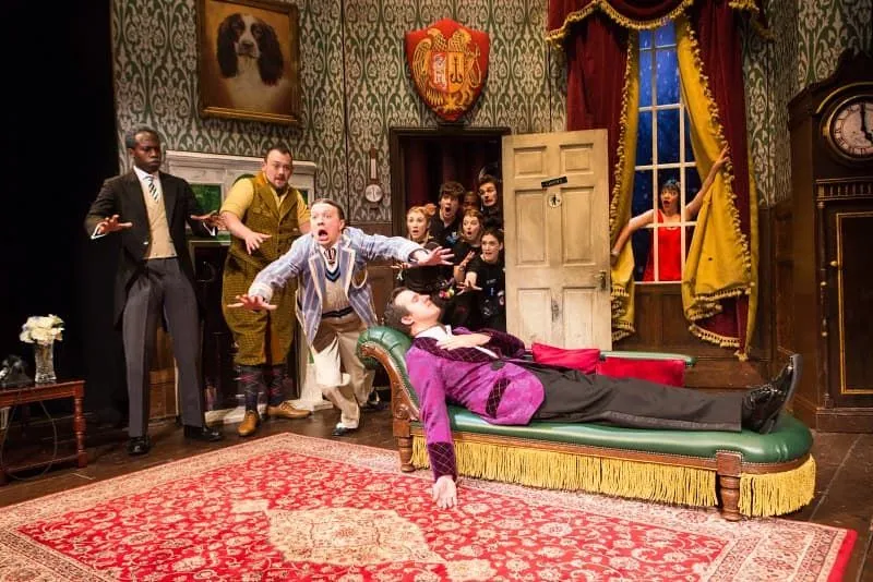 The cast of The Play That Goes Wrong in a farcical stunt on stage.