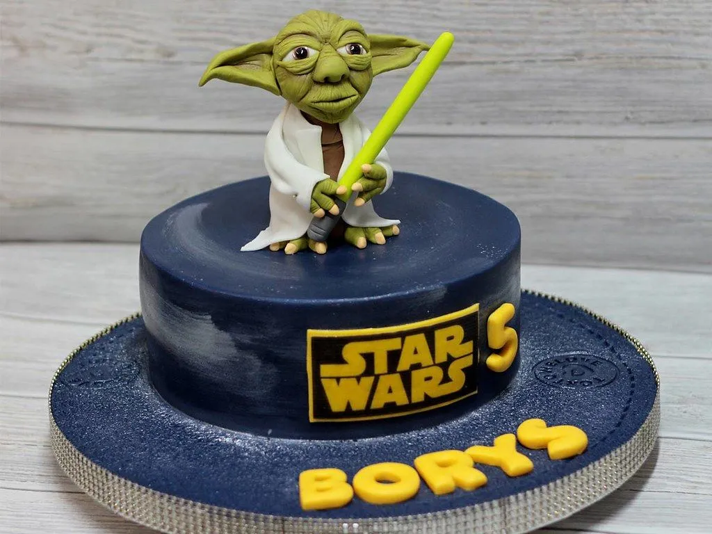 A Star Wars birthday cake with a Yoda cake topper.