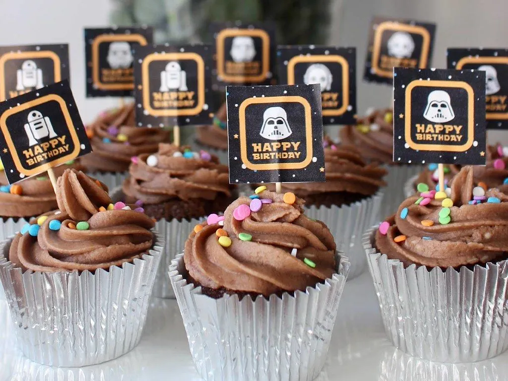 Chocolate cupcakes with mini Star Wars cake toppers.