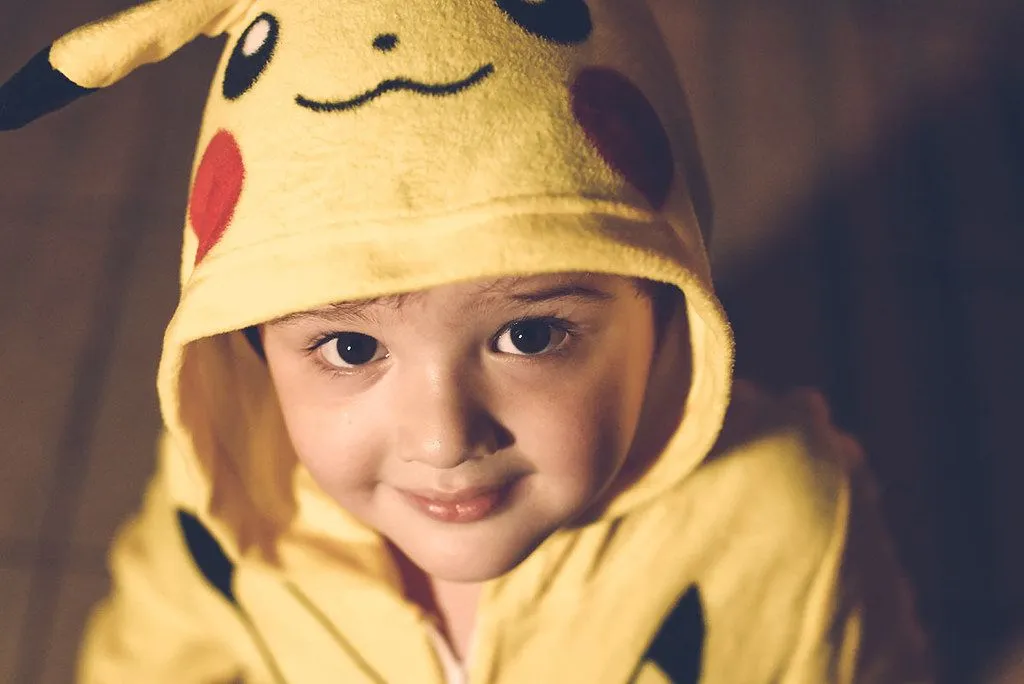 A little boy dressed up as Pikachu.