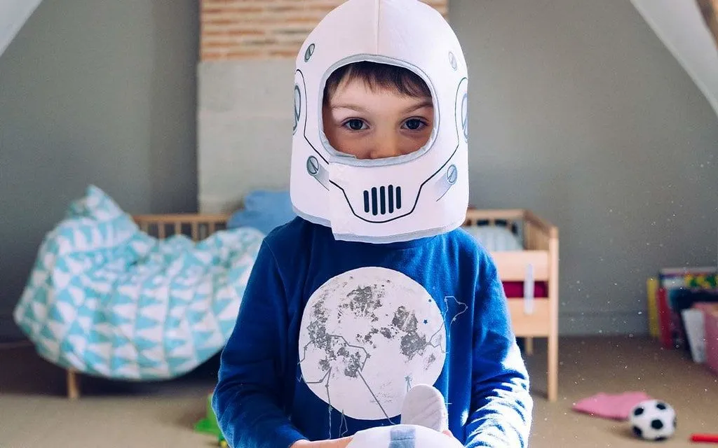 Boy wearing a homemade Star Wars Stormtrooper helmet.