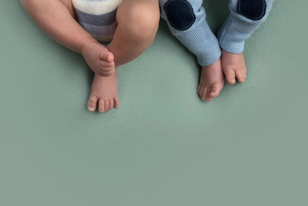 A bird's eye view of twin babies' feet.