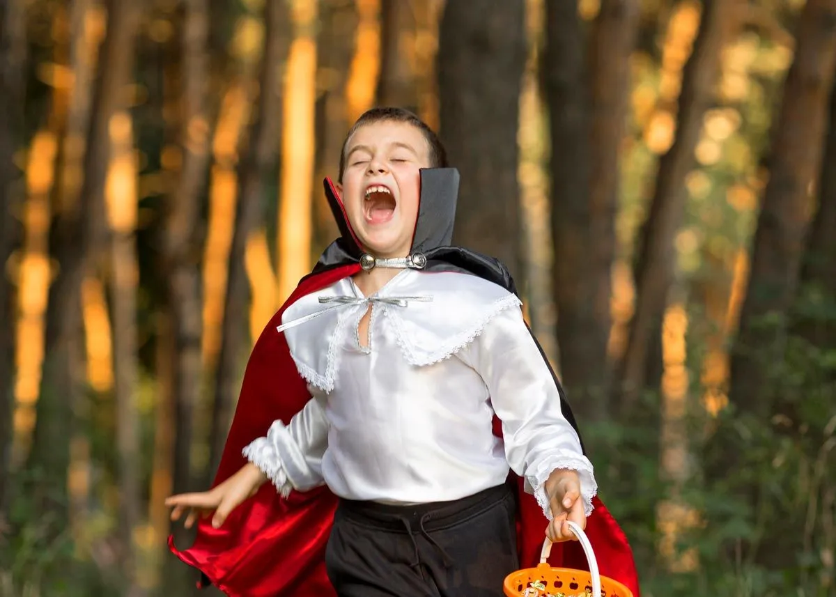 A vampire costume is a great and easy DIY option, like this boy who is running through the forest dressed as a vampire.