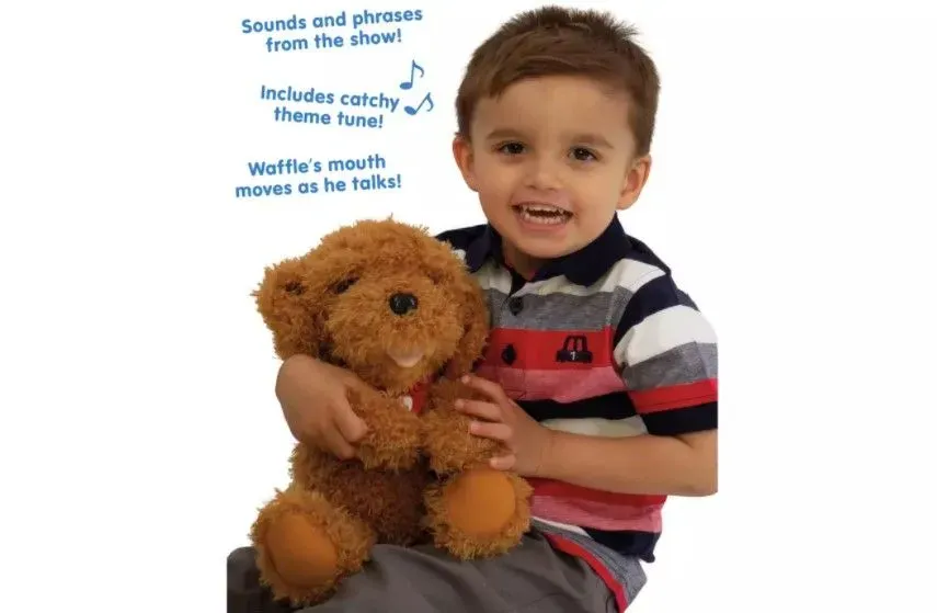  Little boy holding a super cuddly Waffle the Wonder Soft Toy.