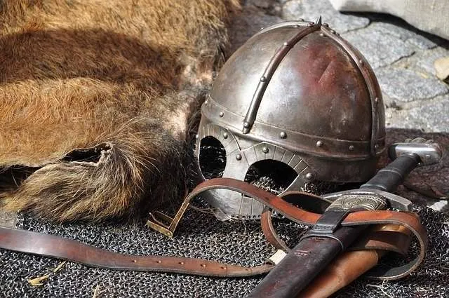 Medieval knight's armor, sword and battle headgear.