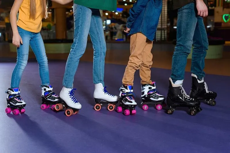 Parents and kids skating on roller rink together