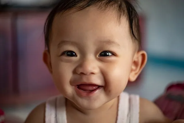 A baby boy smiling at the camera