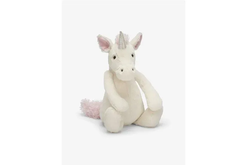 Sitting white soft and fluffy unicorn.