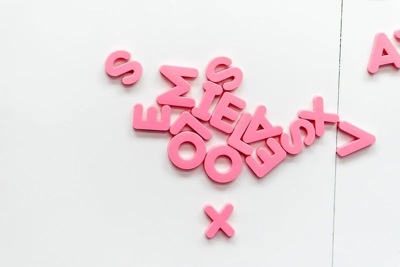 Pink letters creating puns on a white background. Image