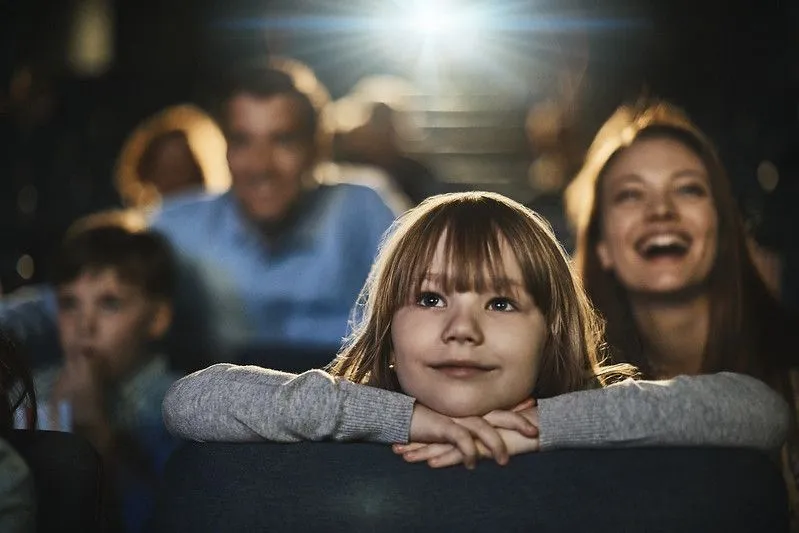 A family watching a show or movie at the theatre. Image
