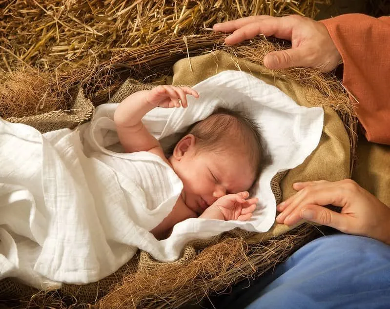 Baby in manger at their first Christmas. 