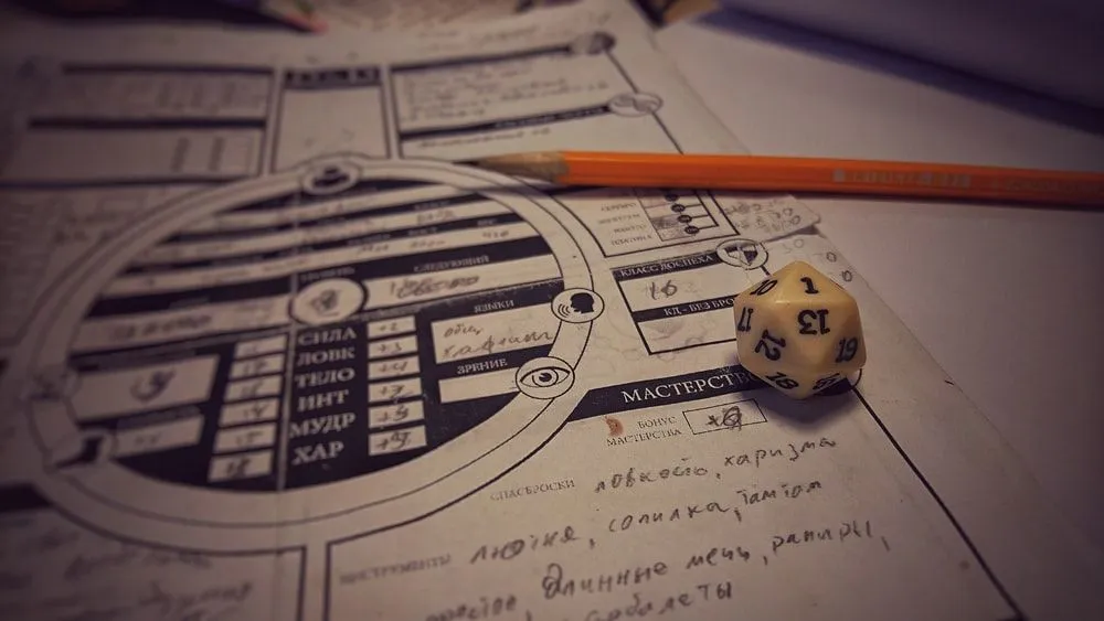 A white dice on the paper with game strategy of 'Dungeons And Dragons' 