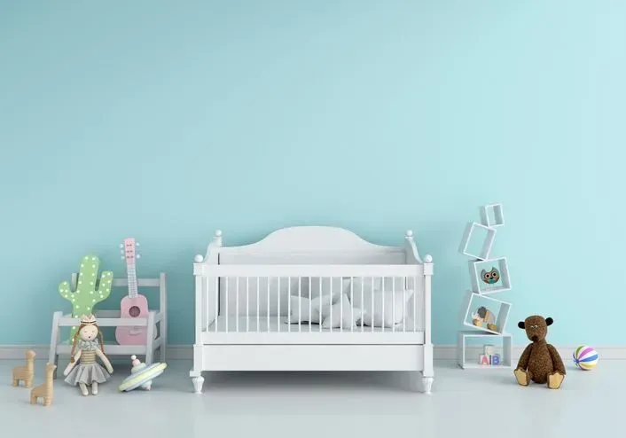 Doll cot in bedroom with toys. 
