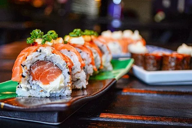 Sushi is prepared with raw fish rolls.