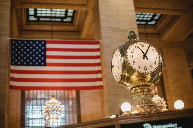 A vintage clock and the American flag.
