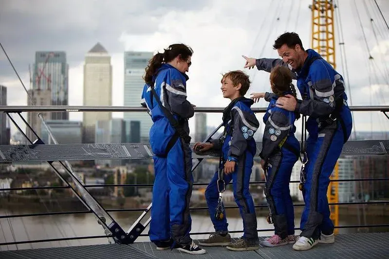 A family looking out at Canary Wharf from on top of the O2.
