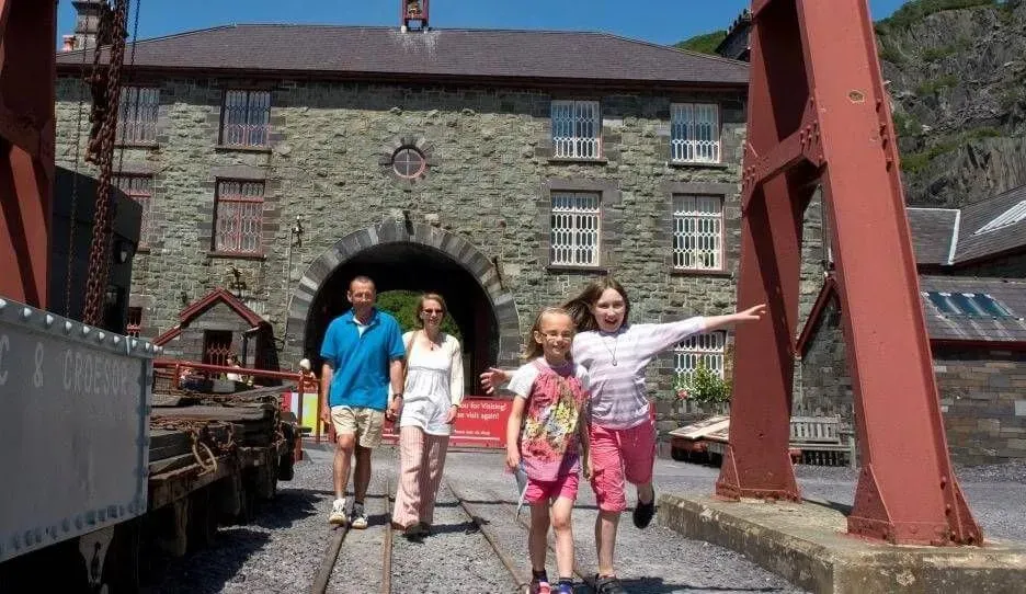 A family of four walking outside the National Slate Museum.
