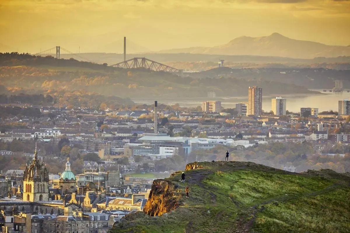 A view from the top of Arthur's Seat, of the foggy landscape showing Edinburgh and beyond.