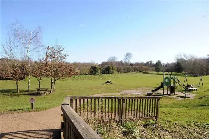 Play area and green field at Needham Lake and Nature Reserve.