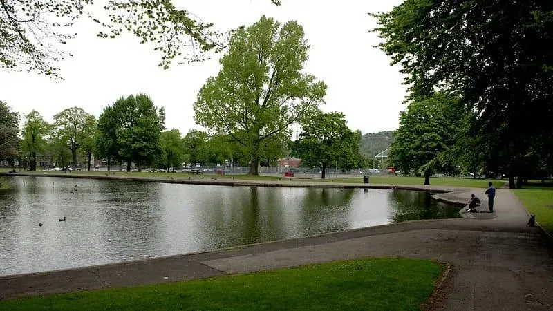 The large pond lake of Hillsborough Park surrounding by a pathway.
