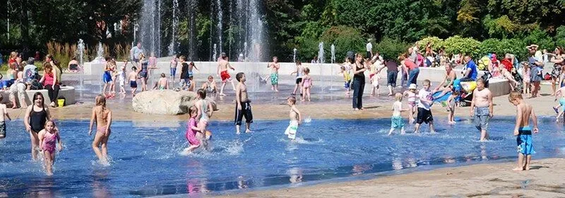 Children playing in the water splash zone at Clifton Park and Museum.