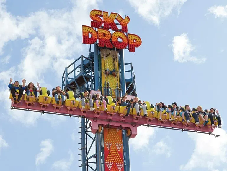 A row of people at the top of the Sky Drop roller coaster at Great Yarmouth Pleasure Beach.