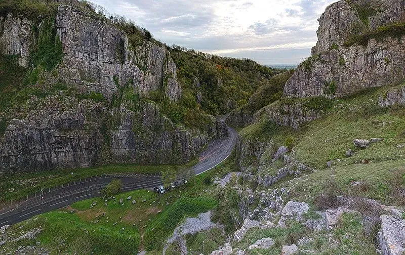 View of the steep road running through the green hills of Cheddar Gorge.