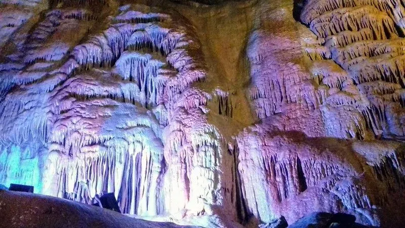 A view of the colourful purple and blue lights reflecting off the cave's interior at Cheddar Gorge.