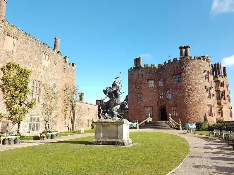 A life-size statue of Fame and Pegasus, the winged horse, standing in the gardens of Powis Castle.