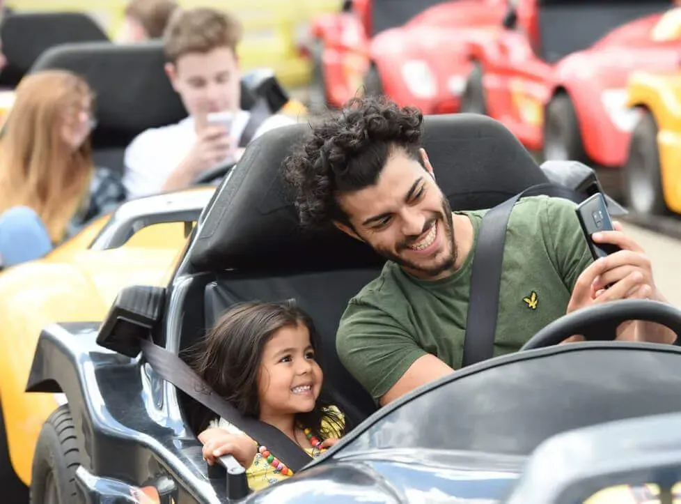 Man and girl on the dodgems at Wicksteed Park.