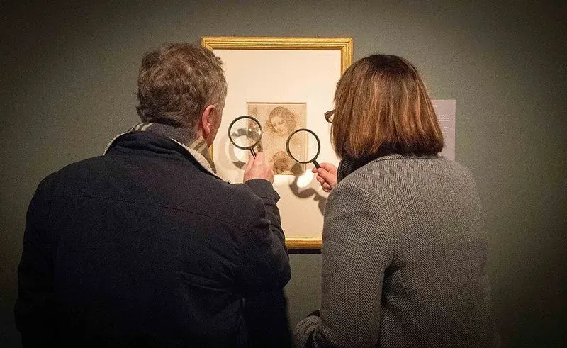 Two people looking at Derby Museum and Art Gallery painting.