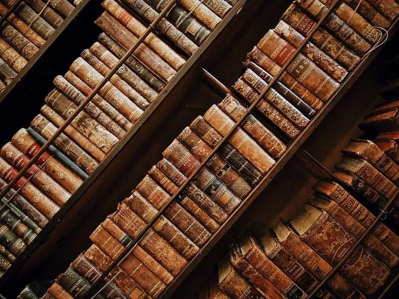 Close up of old books stacked in the British Library.