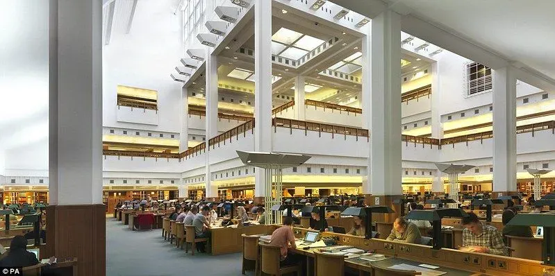 Inside British Library, desks and open plan space with pillars and lot of light.