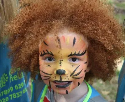 Child with lion facepaint.