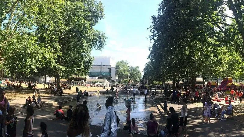 People gathered around water feature at Coram's Fields.