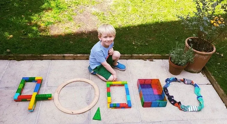 Child playing with bricks and other toys.