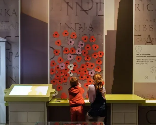Children underneath monument of poppies at National Army Museum.