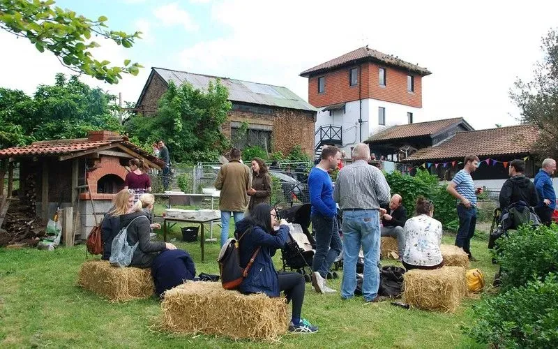 People sat on hay bales at Surrey Docks Farm Fair.