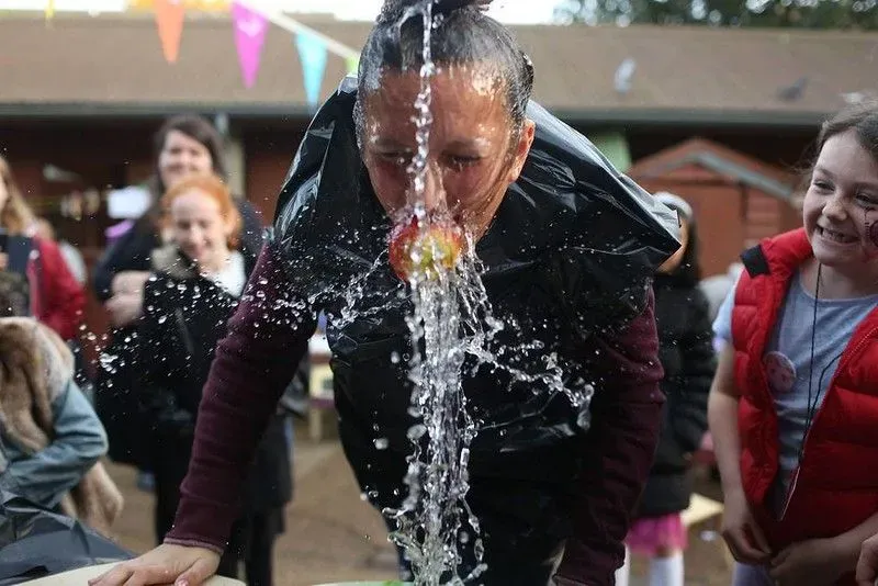 Child in apple bobbing competition.