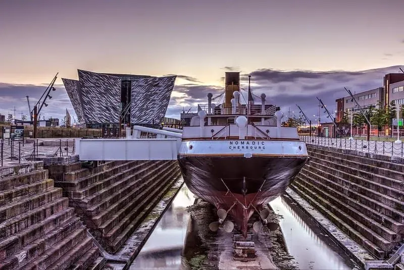 The SS Nomadic vessel berthed next to Titanic Belfast in the historic Hamilton Dry Dock.