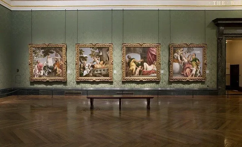 Paintings hanging on exhibition wall of National Gallery.