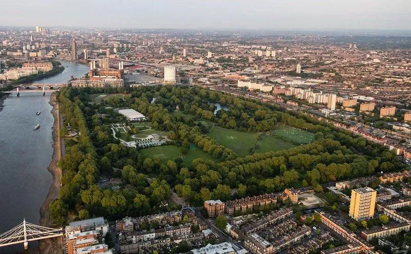 Aerial view of Battersea Park and the Thames in late afternoon.