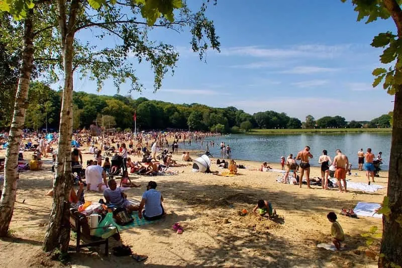 Ruislip Lido in the summer, packed with people.