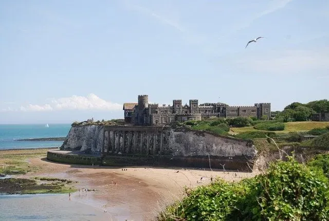 Castle on the cliff edge right by the seashore at Kingsgate Bay.