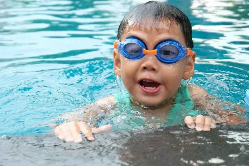 Toddler wearing goggles in the water at Aylesbury Swimming Pool.