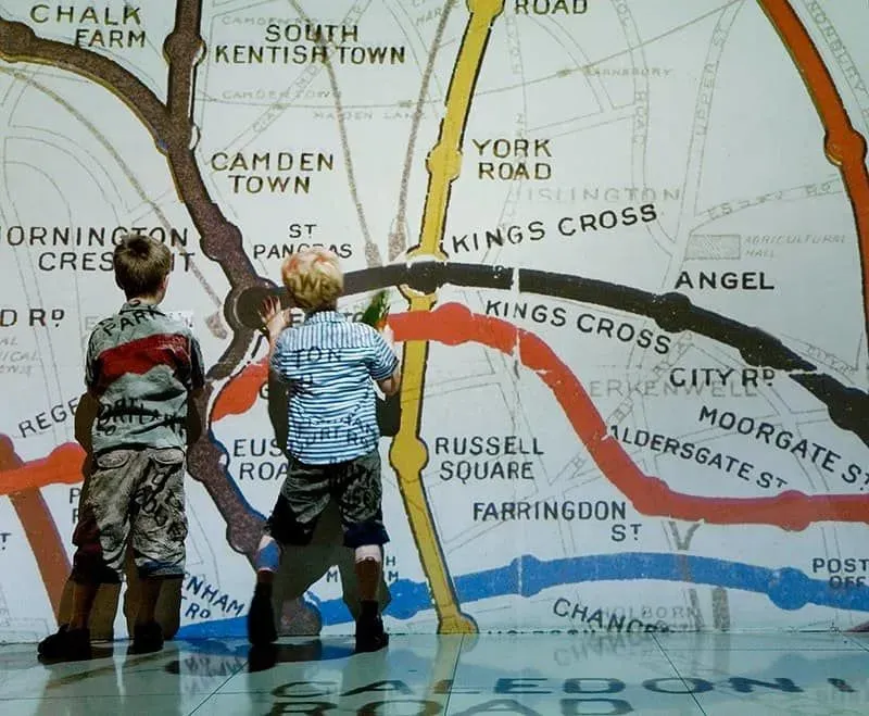 Children exploring a wall of the Underground map.