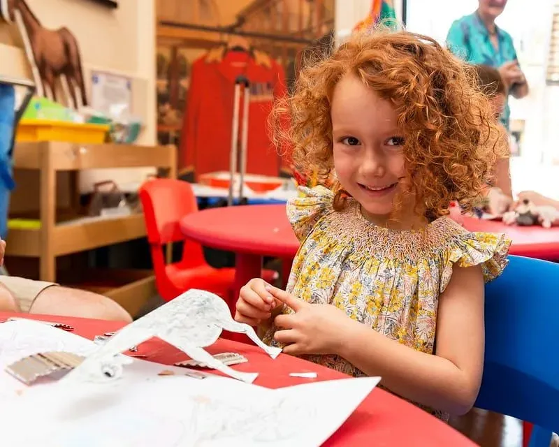 A child enjoying an arts and crafts activity at the Royal Mews.